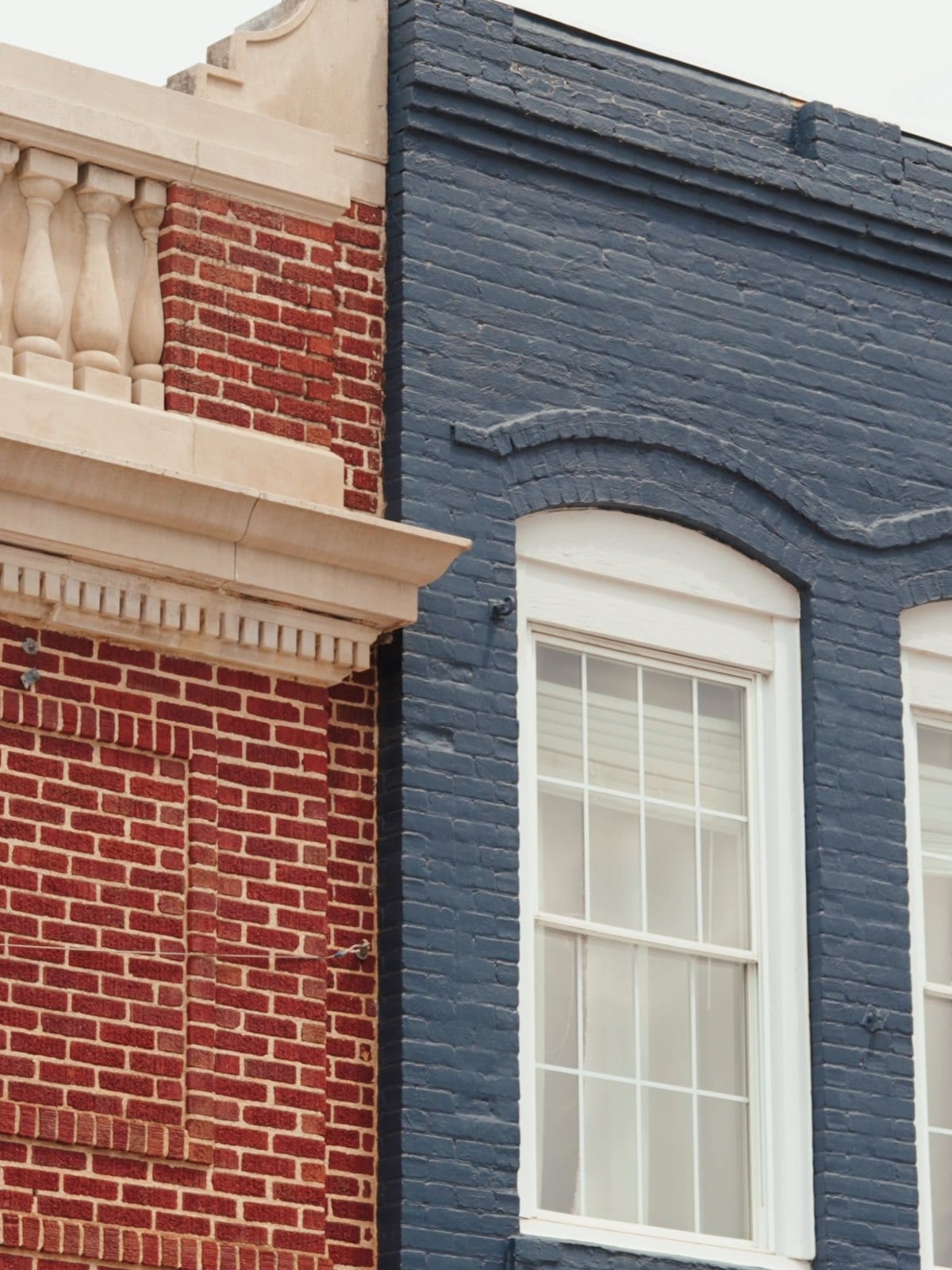 Historic red-brick and painted-brick storefronts with a moulded cornice on Fort Mill's Main Street