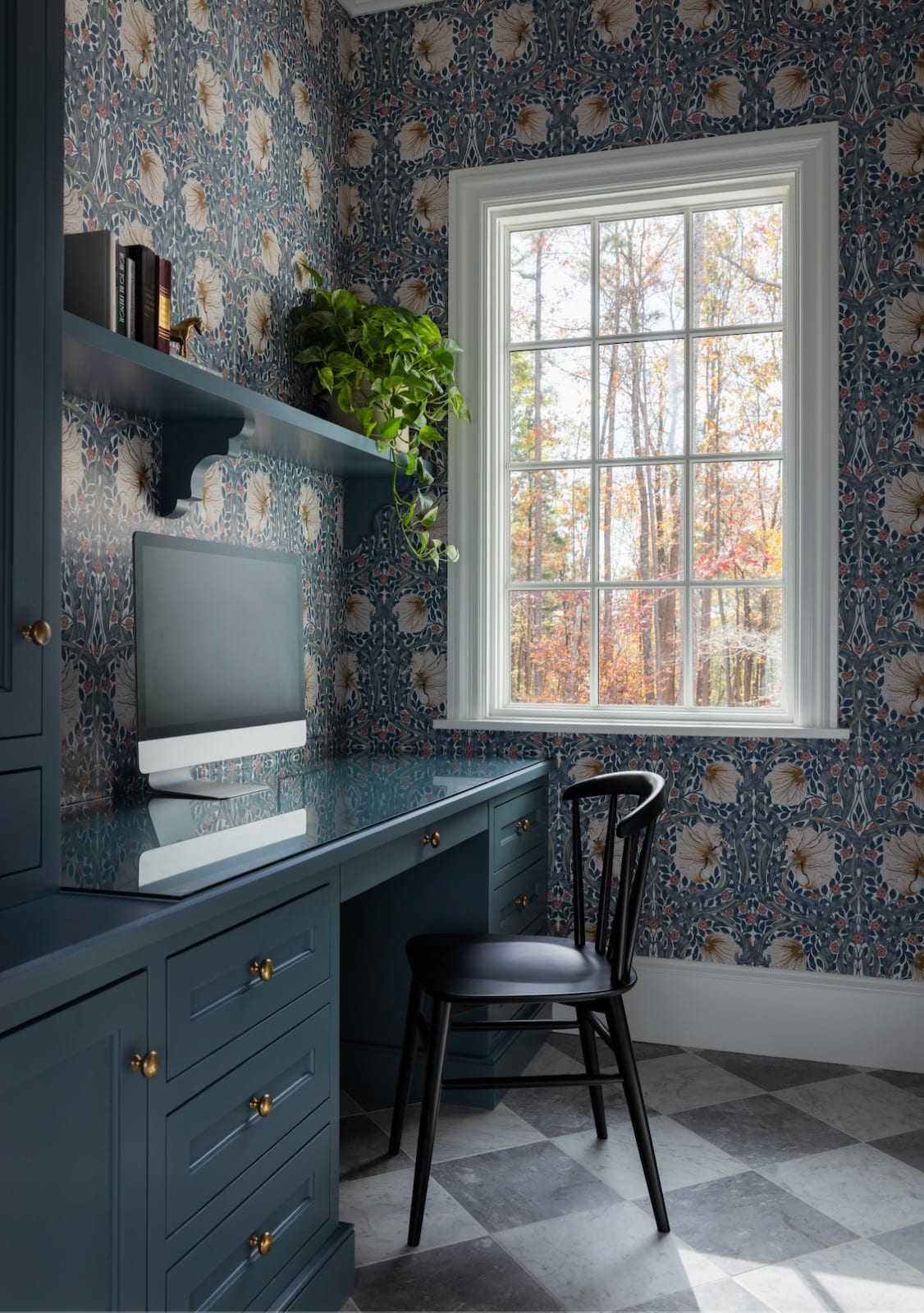 Study at Meadowbrook Cottage with deep-blue built-in cabinetry, patterned wallpaper and a window over the desk
