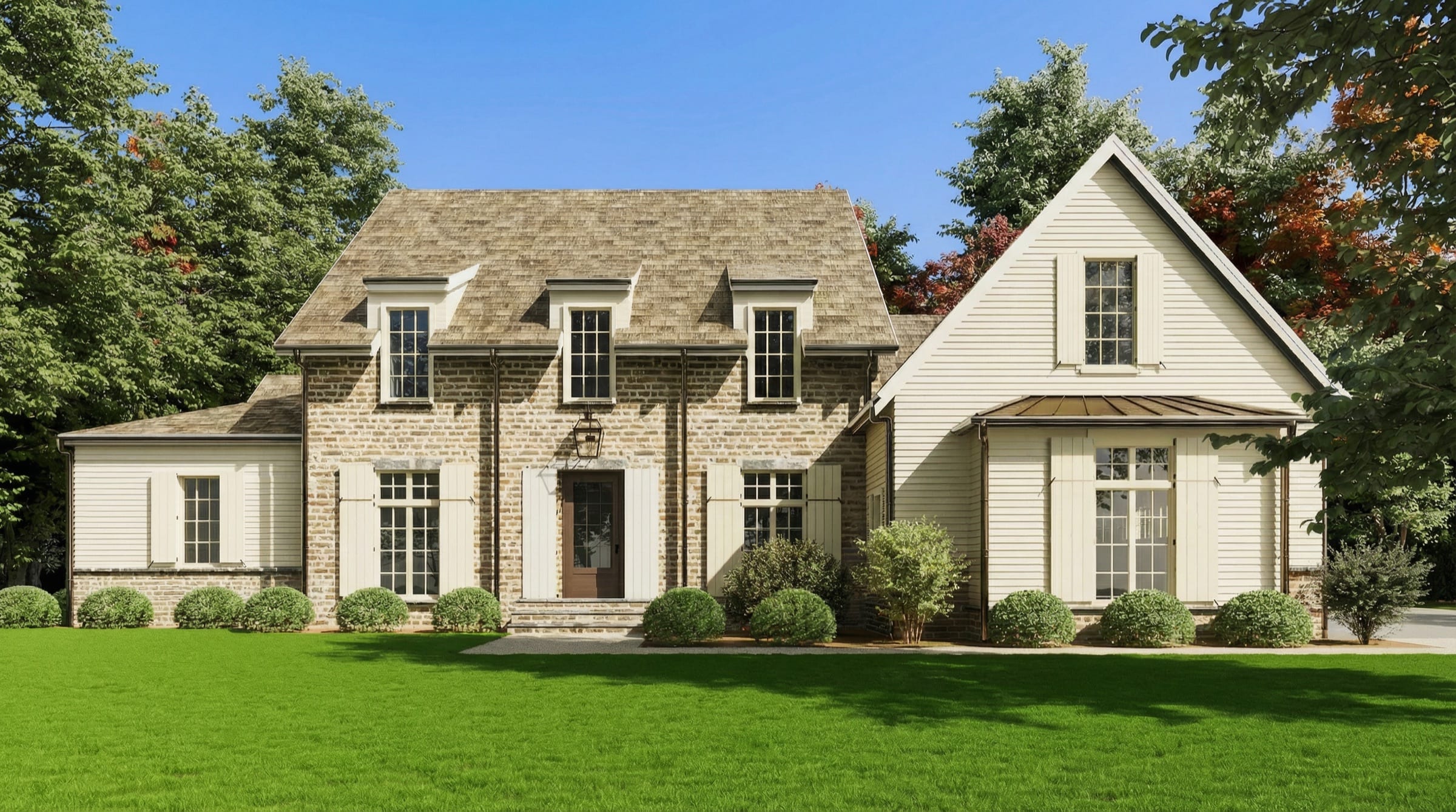 Stone and clapboard exterior of a custom home at Wilson Farm, framed by mature trees